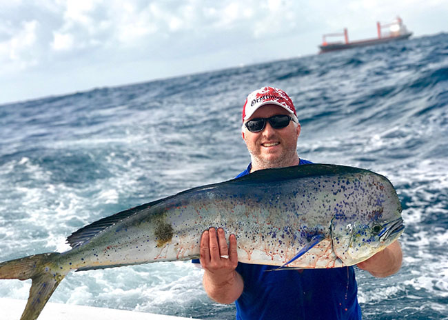 Francis showing off the big game he caught in the past fishing trip.